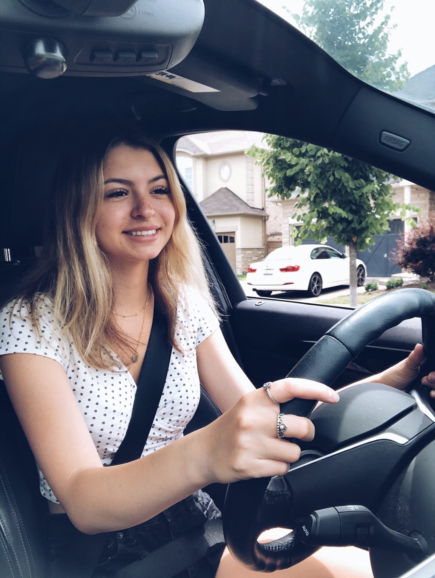 Young teenage girl is happy smiling while taking her first driving lessons